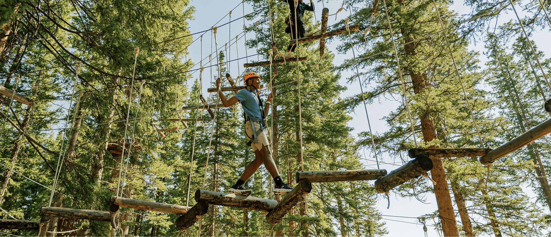Child walks on ropes course at Snowmass's lost forest