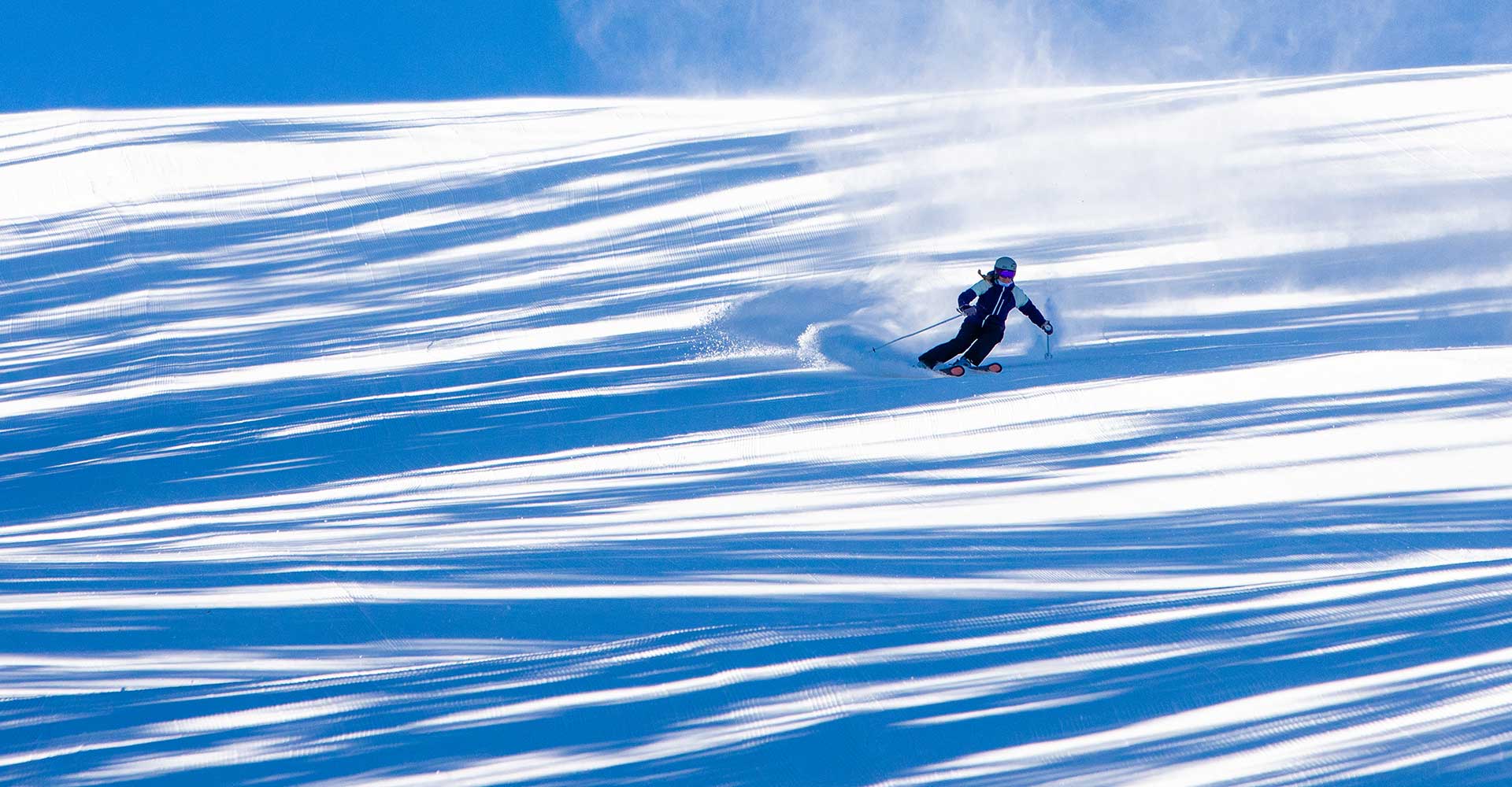 A skier on a wide-open "groomer" at Aspen Snowmass.