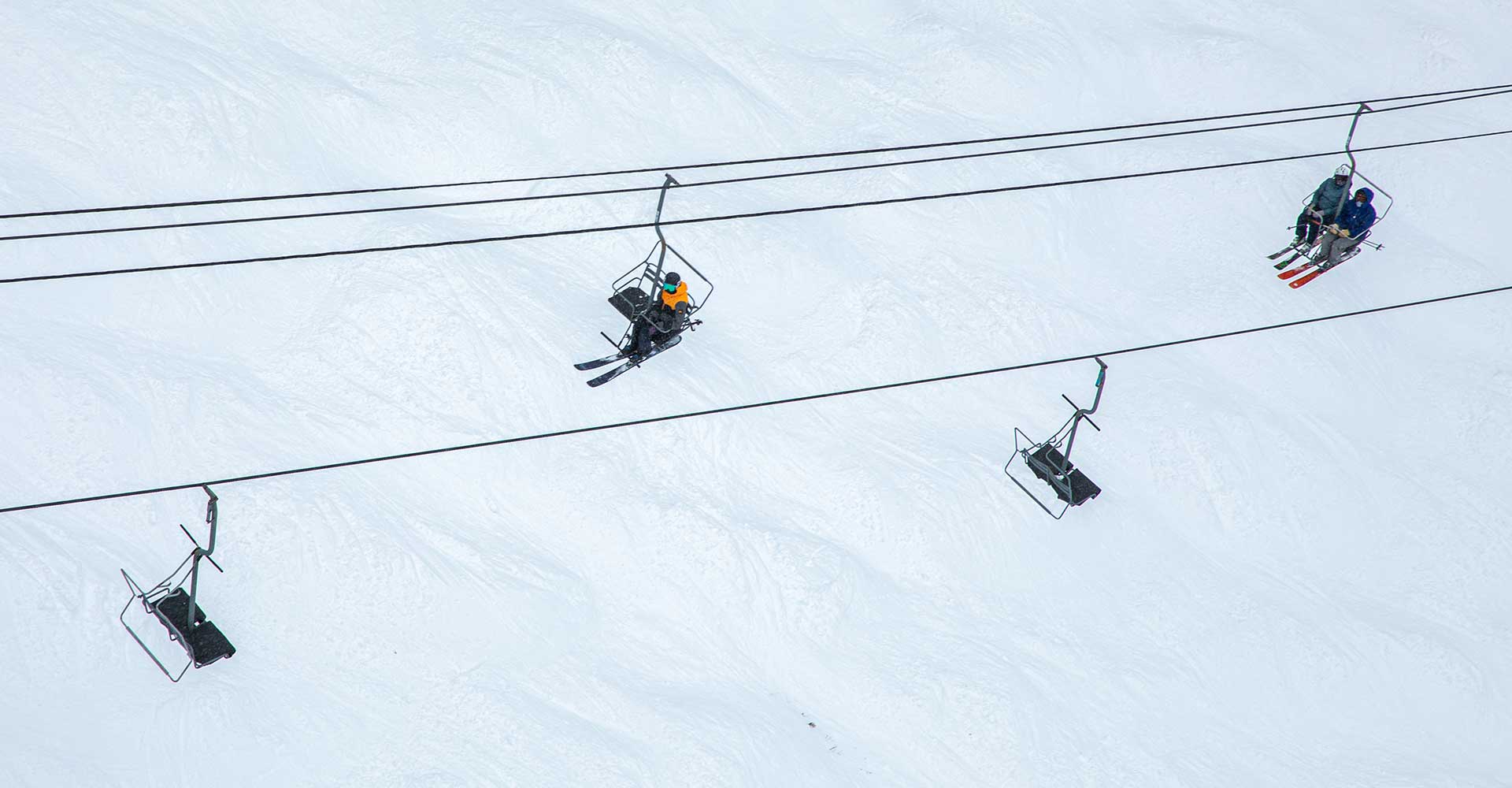 An aerial photo of a double chairlift at Aspen Snowmass