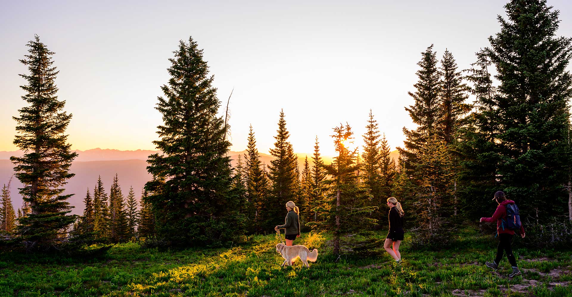 Three friends hiking on Snowmass Mountain at dawn