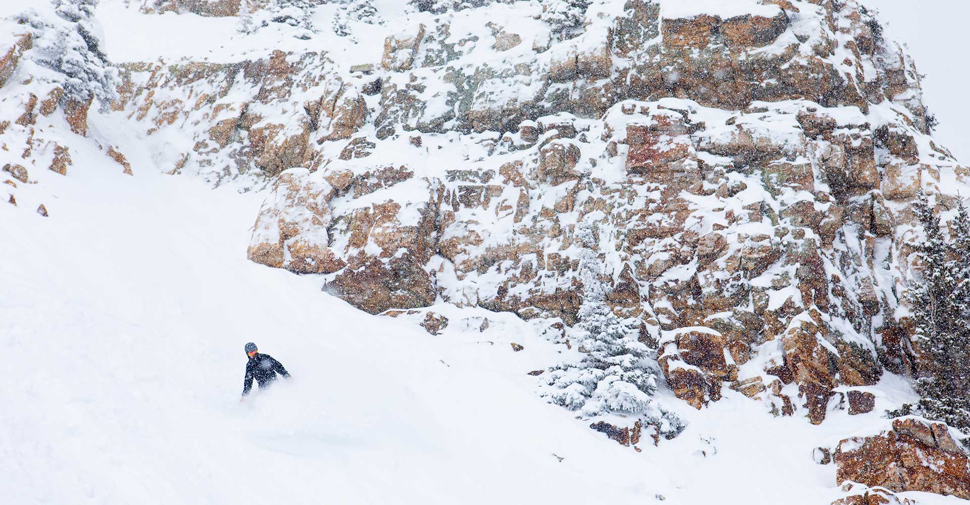 An expert snowboarder navigates the steeps at Snowmass.