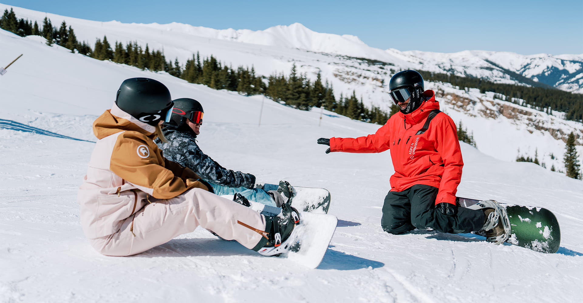Snowboard Pro guides his students on proper boarding techniques