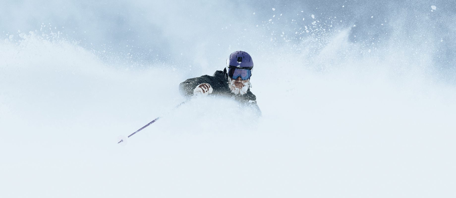 man in deep powder at aspen highlands