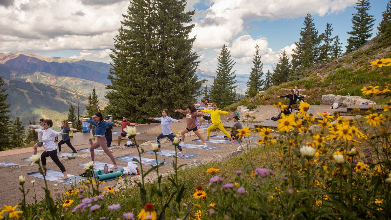 a group of people doing yoga outside