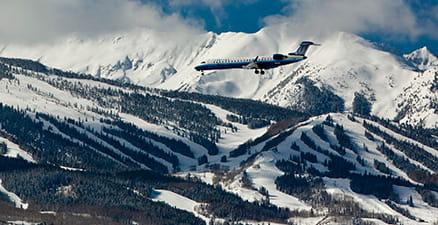 Airplane landing with Snowmass in background