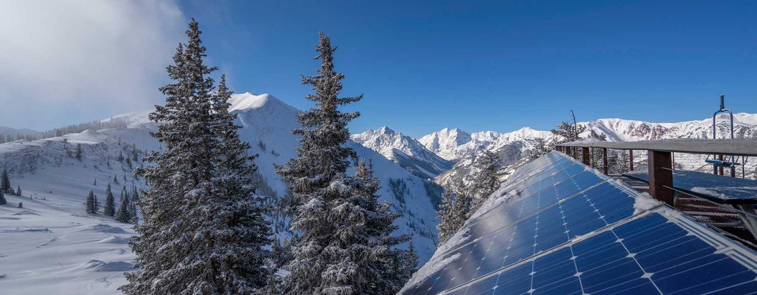 Solar panels at Aspen Highlands with Maroon Bells